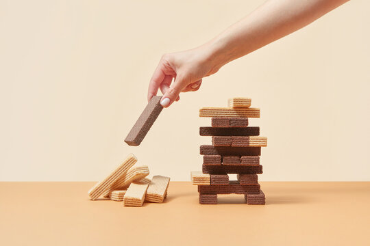 Woman building waffles balanced tower