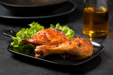 Roasted chicken pieces with lettuce salad.