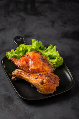 Roasted chicken pieces with lettuce salad.