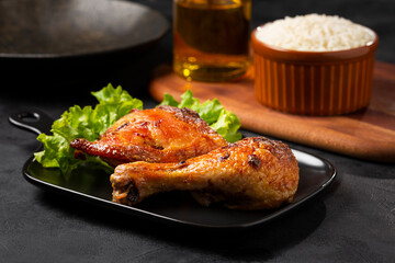 Roasted chicken pieces with lettuce salad.