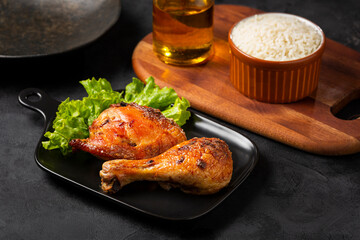 Roasted chicken pieces with lettuce salad.