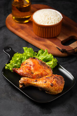 Roasted chicken pieces with lettuce salad.
