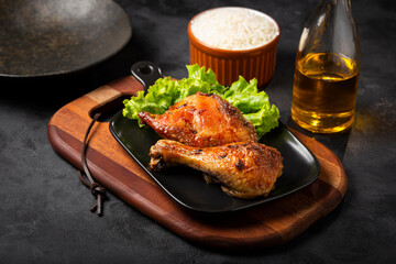 Roasted chicken pieces with lettuce salad.
