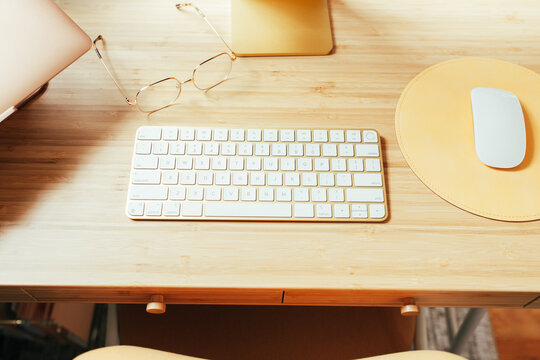 Bamboo Desk With Glasses, Keyboard And Mouse Pad On Top