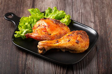 Roasted chicken pieces with lettuce salad.