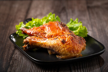 Roasted chicken pieces with lettuce salad.