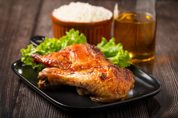 Roasted chicken pieces with lettuce salad.