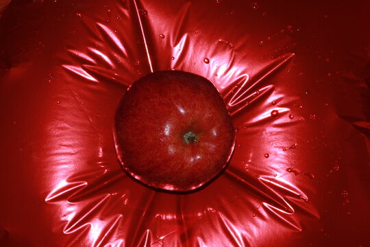 Red apple on red foil