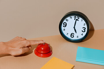 man rings a red call bell at five