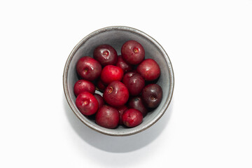 Fresh ripe cherries in a cup on a white background. Healthy eating. Dessert. Vegetarian breakfast.