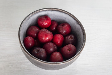 Fresh ripe cherries in a cup on a white background. Vegetarian breakfast. Dessert. Healthy eating.