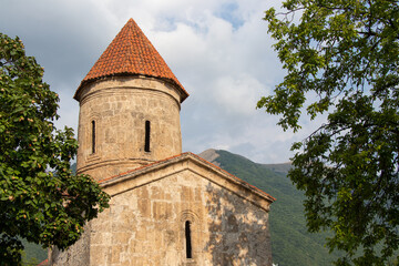 Fototapeta na wymiar Ancient religious buildings in the Caucasus. Old christian temple in the Kish village of Sheki - Azerbaijan