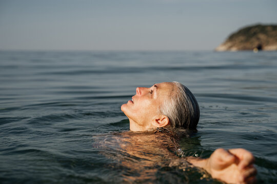 Active Mature Woman Bathing In The Sea In The Morning