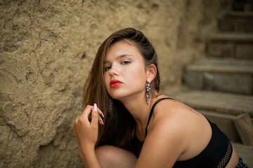Fototapeta premium cheerful young girl spending good time at the beach. Beauty portrait. Сute teenage girl or woman on the beach nature landscape fresh air beach. Natural beauty. lifestyle/ real people/ funny/ dance.