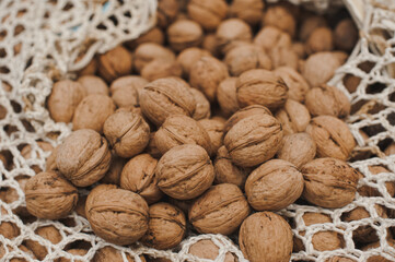 Harvest walnuts in a bag. Whole walnuts in shell. Ripe walnuts.