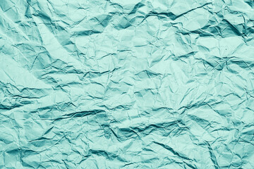 Green crumpled paper background, texture with copy space