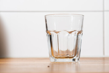 Empty glass on a wooden table..