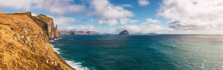 Turquoise sea waving near cliff