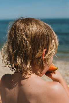 Anonymous boy eats a melon 