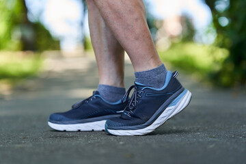 Fototapeta na wymiar Muscular calves and shoes of a runner
