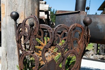 decorative outdoor bin forged of old horse shoes
