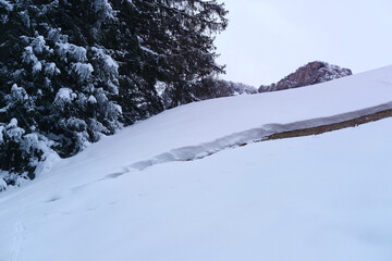 large crack in snow to ground, the beginning of an avalanche, a snow board, a beautiful winter...