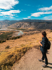 Woman walking along the dirt roads. El chalten, patagonia, Argentina.