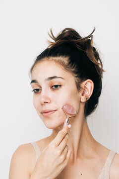 Smiling Woman Using Rose Quartz Face Roller