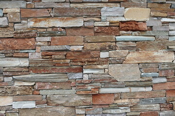 FONDO EN COLORES CÁLIDOS. MURO DE PIEDRAS EN HORIZONTAL. DIFERENTES TONOS. TEXTURA RUGOSA.