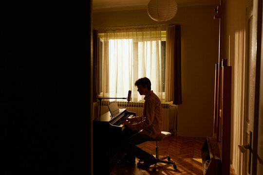 Man Playing The Piano In His Room 