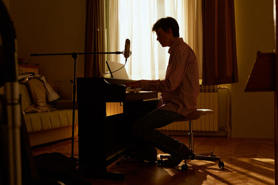 Young Musician Composing At Home 