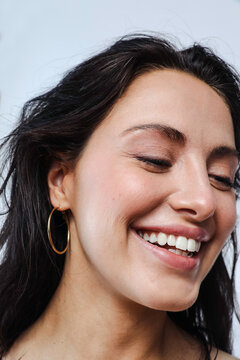 Beautiful young model with natural makeup and earrings