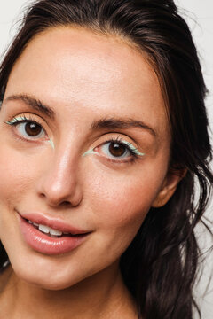 Young woman with green eyeliner makeup on smiling