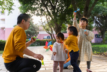 happy asian kids playing in the sunny park
