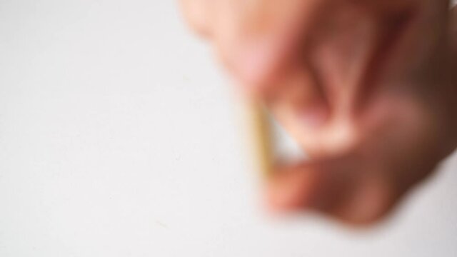 Close up hand with herb capsule on white background. Microdosing concept. Psychedelics therapy. Depression, anxiety treatment 