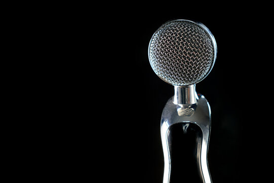 studio microphone isolated on black. Copy space to the left. Music recording concept, blogger's equipment
