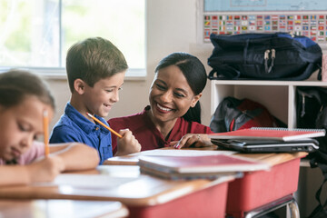School: Teacher Helping Boy With Math Work