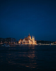 beautiful view from the water on the educated parliament building in night Budapest, side view general plan