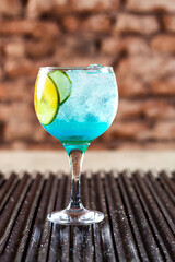 blue drink with ice
classic cocktail glasses
drink at the lemon club
caipirinha, chilled negroni and in a glass.
cocktail isolated on rustic background.