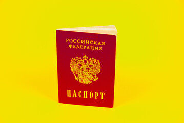 The Russian passport is presented like a book. Yellow background.