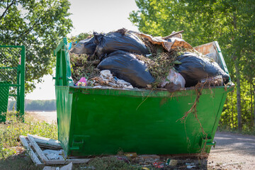 Large trash can with rubbish.