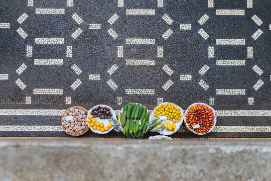 Aerial view of baskets on the sidewalk with tropical fruit in farmer's market 
