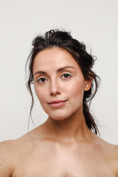 Young woman with green eyeliner makeup on smiling