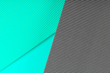 Blue and gray corrugated paper texture. Geometric shapes and lines. Minimalist background. Flat lay. Copy space.
