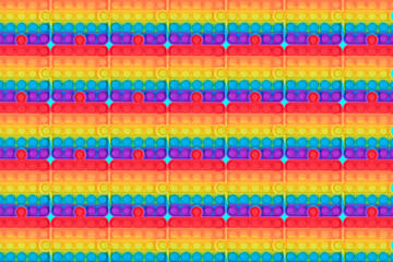 New sensory antistress fidget toys pop it. Rainbow puzzle shape pattern. Trendy push bubble toys for children and adult. Flat lay. - obrazy, fototapety, plakaty