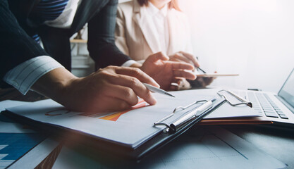 Business people using tablets And using his finger to touch the screen With a business graph showing up in a virtual screen.New startup ideas and business growth concept.