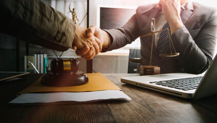 Business and lawyers discussing contract papers with brass scale on desk in office. Law, legal services, advice, justice and law concept picture with film grain effect