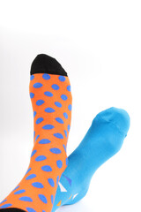 Legs with different a pair of mismatched socks on white background. World Down syndrome day background. Down syndrome awareness concept. Copy space.