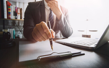 Business and lawyers discussing contract papers with brass scale on desk in office. Law, legal services, advice, justice and law concept picture with film grain effect