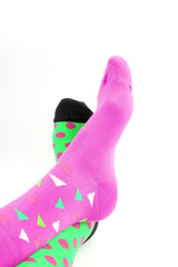 Legs with different a pair of mismatched socks on white background. World Down syndrome day...